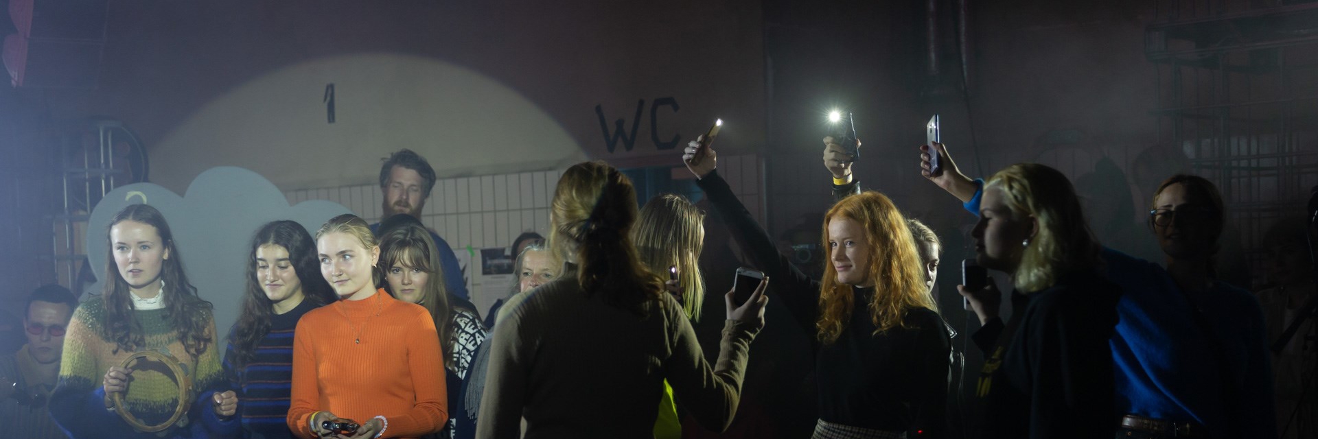 Unge mennesker lyser med deres telefoner  Unge mennesker lyser med deres telefoner